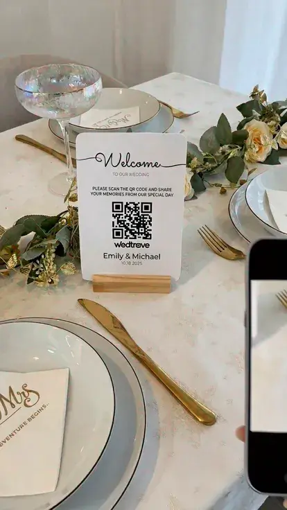 Printed QR code sign displayed at a wedding reception table